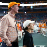
              Former NFL quarterback Peyton Manning, left, stands with his son Marshall Williams Manning, right, on the Tennessee sideline before the Orange Bowl NCAA college football game between Tennessee and Clemson, Friday, Dec. 30, 2022, in Miami Gardens, Fla. Manning played at Tennessee. (AP Photo/Lynne Sladky)
            