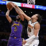 
              Los Angeles Lakers forward Anthony Davis (3) shoots against Denver Nuggets forward Aaron Gordon (50) during the first half of an NBA basketball game in Los Angeles, Friday, Dec. 16, 2022. (AP Photo/Ashley Landis)
            