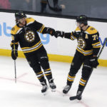 
              Boston Bruins right wing David Pastrnak, left, is congratulated by defenseman Charlie McAvoy after Pastrnak's goal during the second period of the team's NHL hockey game against the Winnipeg Jets, Thursday, Dec. 22, 2022, in Boston. (AP Photo/Mary Schwalm)
            