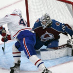 
              Montreal Canadiens right wing Joel Armia, left, tries to direct the puck as Colorado Avalanche goaltender Alexandar Georgiev in the first period of an NHL hockey game Wednesday, Dec. 21, 2022, in Denver. (AP Photo/David Zalubowski)
            