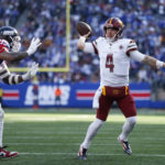 
              Washington Commanders quarterback Taylor Heinicke, right, throws during the first half of an NFL football game against the New York Giants, Sunday, Dec. 4, 2022, in East Rutherford, N.J. (AP Photo/John Munson)
            