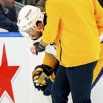 
              Nashville Predators defenseman Ryan McDonagh is helped off the ice with a nosebleed during the third period of an NHL hockey game against the New York Islanders, Friday, Dec. 2, 2022, in Elmont, N.Y. (AP Photo/Julia Nikhinson)
            