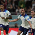 
              England's Marcus Rashford, left, celebrates with teammates after scoring the opening goal during the World Cup group B soccer match between England and Wales, at the Ahmad Bin Ali Stadium in Al Rayyan , Qatar, Tuesday, Nov. 29, 2022. England won 3-0. (AP Photo/Frank Augstein)
            