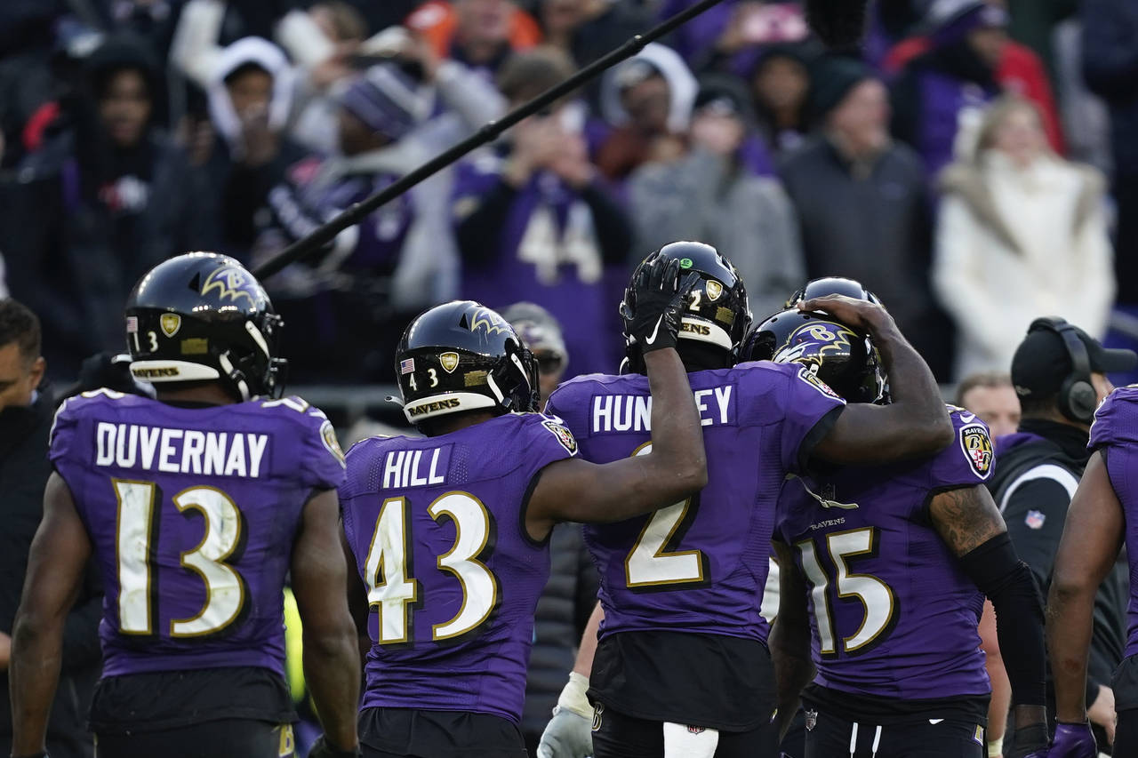 Baltimore Ravens players celebrate a touchdown by Baltimore Ravens quarterback Tyler Huntley (2) in...