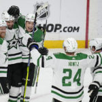 
              Dallas Stars left wing Jamie Benn (14), second from left, celebrates with teammates after scoring a goal during the third period of an NHL hockey game against the Minnesota Wild, Thursday, Dec. 29, 2022, in St. Paul, Minn. (AP Photo/Abbie Parr)
            