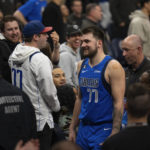 
              Dallas Mavericks guard Luka Doncic (77), center right, leaves the court after being ejected during the second half of an NBA basketball game against the Minnesota Timberwolves, Monday, Dec. 19, 2022, in Minneapolis. (Jeff Wheeler/Star Tribune via AP)
            