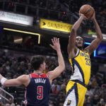
              Indiana Pacers center Myles Turner (33) shoots over Washington Wizards forward Deni Avdija (9) during the first half of an NBA basketball game, Friday, Dec. 9, 2022, in Indianapolis. (AP Photo/Darron Cummings)
            