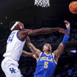 
              Kentucky forward Oscar Tshiebwe and UCLA guard Amari Bailey (5) fight for the ball during the first half of an NCAA college basketball game in the CBS Sports Classic, Saturday, Dec. 17, 2022, in New York. (AP Photo/Julia Nikhinson)
            