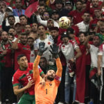 
              France's goalkeeper Hugo Lloris, right, and Morocco's Achraf Hakimi challenge for the ball during the World Cup semifinal soccer match between France and Morocco at the Al Bayt Stadium in Al Khor, Qatar, Wednesday, Dec. 14, 2022. (AP Photo/Martin Meissner)
            