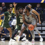 
              West Virginia guard Joe Toussaint (5) is defended by UAB guard Jordan Walker (10) during the first half of an NCAA college basketball game in Morgantown, W.Va., Saturday, Dec. 10, 2022. (AP Photo/Kathleen Batten)
            