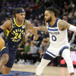 
              Indiana Pacers guard Buddy Hield (24) drives on Minnesota Timberwolves guard D'Angelo Russell (0) in the third quarter of an NBA basketball game, Wednesday, Dec. 7, 2022, in Minneapolis. (AP Photo/Andy Clayton-King)
            