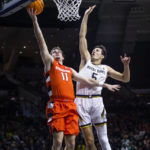 
              Syracuse's Joseph Girard III (11) drives past Notre Dame's Cormac Ryan (5) during the first half of an NCAA college basketball game on Saturday, Dec. 3, 2022 in South Bend, Ind. (AP Photo/Michael Caterina)
            