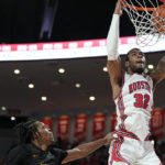 
              Houston forward Reggie Chaney (32) dunks the ball over Norfolk State guard Cahiem Brown (31) during the second half of an NCAA college basketball game, Tuesday, Nov. 29, 2022, in Houston. (AP Photo/Kevin M. Cox)
            