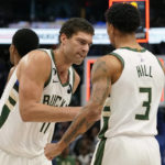 
              Milwaukee Bucks center Brook Lopez (11) is congratulated by guard George Hill (3) after the team's NBA basketball game against the Dallas Mavericks in Dallas, Friday, Dec. 9, 2022. The Bucks won 106-105. (AP Photo/LM Otero)
            
