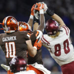 
              New Mexico State linebacker Trevor Brohard, right, intercepts a pass against Bowling Green tight end Levi Gazarek (10) and wide receiver Odieu Hiliare, center, during the first half of the Quick Lane Bowl NCAA college football game, Monday, Dec. 26, 2022, in Detroit. (AP Photo/Al Goldis)
            