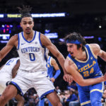 
              Kentucky forward Jacob Toppin (0) guards UCLA guard Jaime Jaquez Jr. (24) during the second half of an NCAA college basketball game in the CBS Sports Classic, Saturday, Dec. 17, 2022, in New York. The Bruins won 63-53. (AP Photo/Julia Nikhinson)
            