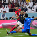 
              Morocco's goalkeeper Yassine Bounou cuts off and attack of France's Kylian Mbappe during the World Cup semifinal soccer match between France and Morocco at the Al Bayt Stadium in Al Khor, Qatar, Wednesday, Dec. 14, 2022. (AP Photo/Natacha Pisarenko)
            