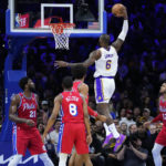 
              Los Angeles Lakers' LeBron James (6) goes up for a dunk during the first half of an NBA basketball game against the Philadelphia 76ers, Friday, Dec. 9, 2022, in Philadelphia. (AP Photo/Matt Slocum)
            