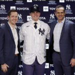 
              New York Yankees' Carlos Rodon, center, poses for a photo with manager Aaron Boone and pitching coach Matt Blake, left, during his introductory baseball news conference at Yankee Stadium, Thursday, Dec. 22, 2022, in New York. (AP Photo/Adam Hunger)
            