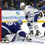 
              Tampa Bay Lightning goaltender Andrei Vasilevskiy (88) makes a save on a shot by Toronto Maple Leafs center Auston Matthews (34) during the first period of an NHL hockey game Saturday, Dec. 3, 2022, in Tampa, Fla. Defending for the Lightning is Ian Cole (28). (AP Photo/Chris O'Meara)
            