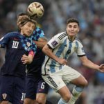 
              Argentina's Julian Alvarez, right, and Croatia's Luka Modric challenge for the ball during the World Cup semifinal soccer match between Argentina and Croatia at the Lusail Stadium in Lusail, Qatar, Tuesday, Dec. 13, 2022. (AP Photo/Martin Meissner)
            