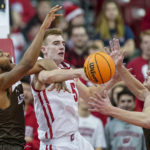 
              Lehigh's Jakob Alamudun, left, and Dominic Parolin (35) battle for a rebound against Wisconsin's Tyler Wahl (5) during the first half of an NCAA college basketball game Thursday, Dec. 15, 2022, in Madison, Wis. (AP Photo/Andy Manis)
            