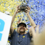 
              Michigan head coach Jim Harbaugh holds the trophy after defeating Purdue in the Big Ten championship NCAA college football game, early Sunday, Dec. 4, 2022, in Indianapolis. Michigan won, 43-22. (AP Photo/Michael Conroy)
            