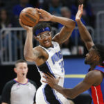 
              Orlando Magic center Wendell Carter Jr. (34) passes the ball as Detroit Pistons center Isaiah Stewart defends during the first half of an NBA basketball game Wednesday, Dec. 28, 2022, in Detroit. (AP Photo/Duane Burleson)
            