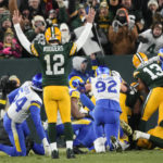 
              Green Bay Packers quarterback Aaron Rodgers (12) celebrates a touchdown by running back AJ Dillon (28) in the first half of an NFL football game against the Los angles Rams in Green Bay, Wis. Monday, Dec. 19, 2022. (AP Photo/Morry Gash)
            