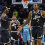 
              LA Clippers guard John Wall and forward Kawhi Leonard (2) celebrate after taking the lead against the Charlotte Hornets during the second half of an NBA basketball game on Monday, Dec. 5, 2022, in Charlotte, N.C. (AP Photo/Scott Kinser)
            