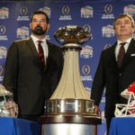 
              Ohio State head coach Ryan Day, left and Georgia head coach Kirby Smart stand with the trophy during a news conference ahead of Saturday's Peach Bowl NCAA college football game Friday, Dec. 30, 2022, in Atlanta. (AP Photo/John Bazemore)
            