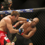 
              FILE - Anderson Silva, right, of Brazil, fights Stephan Bonnar, of the United States, during their light heavyweight mixed martial arts bout at the Ultimate Fighting Championship (UFC) 153 in Rio de Janeiro, Oct. 14, 2012. UFC says former fighter Bonnar, who played a significant role in the UFC’s growth into the dominant promotion in mixed martial arts, has died. The UFC Hall of Famer was 45. UFC announced in a statement that Bonnar died Thursday, Dec. 22, 2022, from “presumed heart complications while at work.” (AP Photo/Felipe Dana, File)
            