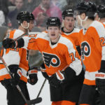 
              Philadelphia Flyers right wing Owen Tippett (74) celebrates with teammates after scoring against the San Jose Sharks during the third period of an NHL hockey game in San Jose, Calif., Thursday, Dec. 29, 2022. (AP Photo/Jeff Chiu)
            
