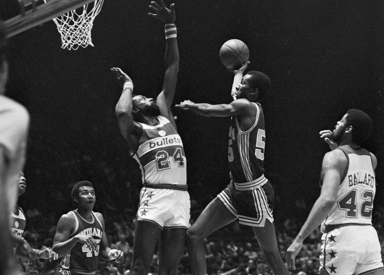 FILE - Indiana Pacers' Louis Orr drives to the basket as Washington Bullets' Spencer Haywood (24) g...