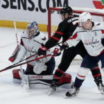 
              Ottawa Senators left wing Brady Tkachuk deflects the puck wide of the net under pressure from Washington Capitals defenseman Dmitry Orlov, right, as Capitals goaltender Darcy Kuemper watches during the second period of an NHL hockey game Thursday, Dec. 22, 2022, in Ottawa, Ontario. (Adrian Wyld/The Canadian Press via AP)
            