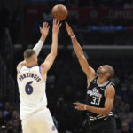 
              Washington Wizards' Kristaps Porzingis (6) shoots over Los Angeles Clippers Nicolas Batum (33) during the first half of an NBA basketball game Saturday, Dec. 17, 2022, in Los Angeles. (AP Photo/Marcio Jose Sanchez)
            