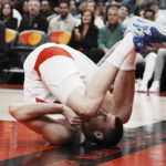 
              Toronto Raptors' Juancho Hernangomez clutches his ankle as he goes down during the first half of an NBA basketball game, Saturday, Dec. 3, 2022 in Toronto. (Chris Young/The Canadian Press via AP)
            