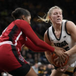 
              North Carolina State center Camille Hobby, left, tries to steal the ball from Iowa forward Monika Czinano during the second half of an NCAA college basketball game, Thursday, Dec. 1, 2022, in Iowa City, Iowa. North Carolina State won 94-81. (AP Photo/Charlie Neibergall)
            