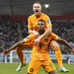 
              Denzel Dumfries of the Netherlands, bottom, is congratulated after scoring his side's 3rd goal during the World Cup round of 16 soccer match between the Netherlands and the United States, at the Khalifa International Stadium in Doha, Qatar, Saturday, Dec. 3, 2022. (AP Photo/Ashley Landis)
            