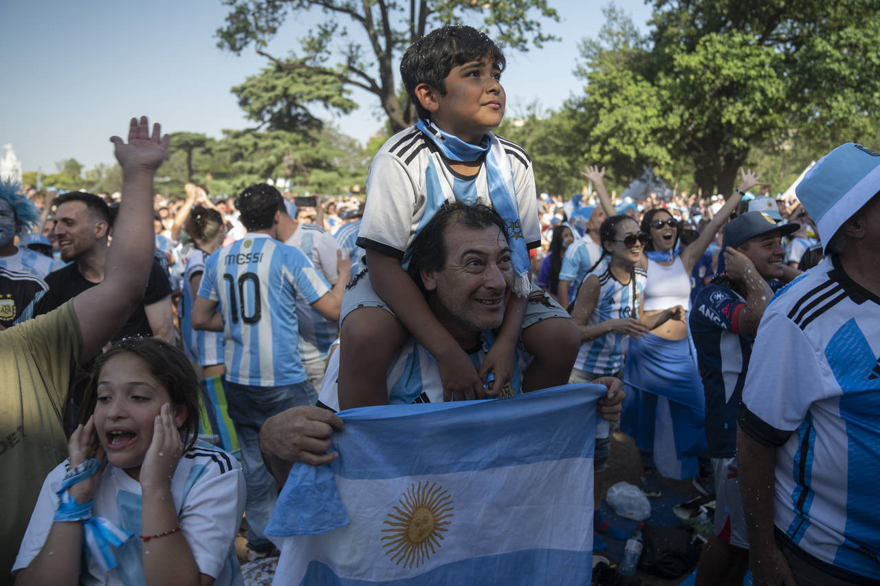 Argentina soccer fans celebrate their team's victory over Croatia in a World Cup semifinal match af...