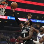 
              Los Angeles Clippers guard John Wall, left shoots as Sacramento Kings guard Terence Davis defends during the first half of an NBA basketball game Saturday, Dec. 3, 2022, in Los Angeles. (AP Photo/Mark J. Terrill)
            