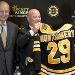 
              Boston Bruins newly hired head coach Jim Montgomery, center, displays a Bruins jersey while standing with team owner Jeremy Jacobs, left, and CEO Charlie Jacobs, right, during a news conference, Monday, July 11, 2022, in Boston. The Bruins hired Montgomery at the start of the 2022 season as their new coach, giving the hockey lifer another chance at an NHL head-coaching job less than three years since he lost his first one. (AP Photo/Steven Senne, File)
            