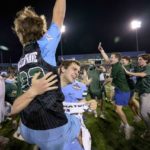 
              Tulane punter Ethan Greenberg holds a fan as they celebrate the team's victory against Central Florida at the end of the American Athletic Conference championship NCAA college football game in New Orleans, Saturday, Dec. 3, 2022. (AP Photo/Matthew Hinton)
            