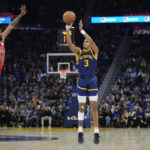 
              Golden State Warriors guard Jordan Poole (3) shoots a 3-point basket next to Chicago Bulls guard Coby White (0) during the first half of an NBA basketball game in San Francisco, Friday, Dec. 2, 2022. (AP Photo/Godofredo A. Vásquez)
            