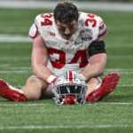 
              Ohio State tight end Mitch Rossi (34) sits on the turf after the Peach Bowl NCAA college football semifinal playoff game between Georgia and Ohio State, Sunday, Jan. 1, 2023, in Atlanta. Georgia won 42-41. (AP Photo/Danny Karnik)
            