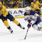 
              Edmonton Oilers center Connor McDavid (97) moves the puck past Nashville Predators defenseman Mattias Ekholm (14) during the first period of an NHL hockey game Monday, Dec. 19, 2022, in Nashville, Tenn. (AP Photo/Mark Zaleski)
            