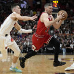 
              Chicago Bulls guard Goran Dragic, right, drives to the basket as Miami Heat guard Tyler Herro defends during the first half of an NBA basketball game, Tuesday, Dec. 20, 2022, in Miami. (AP Photo/Lynne Sladky)
            