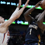 
              New Orleans Pelicans forward Zion Williamson (1) shoots against Phoenix Suns forward Dario Saric in the second half of an NBA basketball game in New Orleans, Sunday, Dec. 11, 2022. The Pelicans won 129-124. (AP Photo/Gerald Herbert)
            