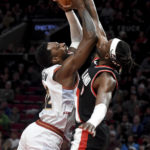 
              Portland Trail Blazers forward Jerami Grant, right, is called for a foul as he blocks the shot of Denver Nuggets forward Jeff Green during the first half of an NBA basketball game in Portland, Ore., Thursday, Dec. 8, 2022. (AP Photo/Steve Dykes)
            