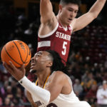 
              Arizona State guard Frankie Collins, left, shoots as he collides with Stanford guard Michael O'Connell (5) during the second half of an NCAA college basketball game in Tempe, Ariz, Sunday, Dec. 4, 2022. (AP Photo/Ross D. Franklin)
            
